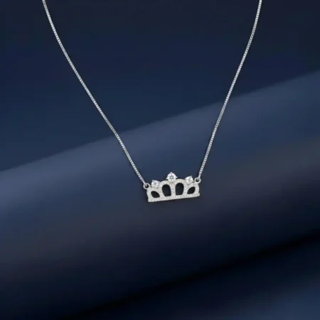 "Sparkling sterling silver Princess Crown Pendant Necklace with cubic zirconia stones on a white marble background."