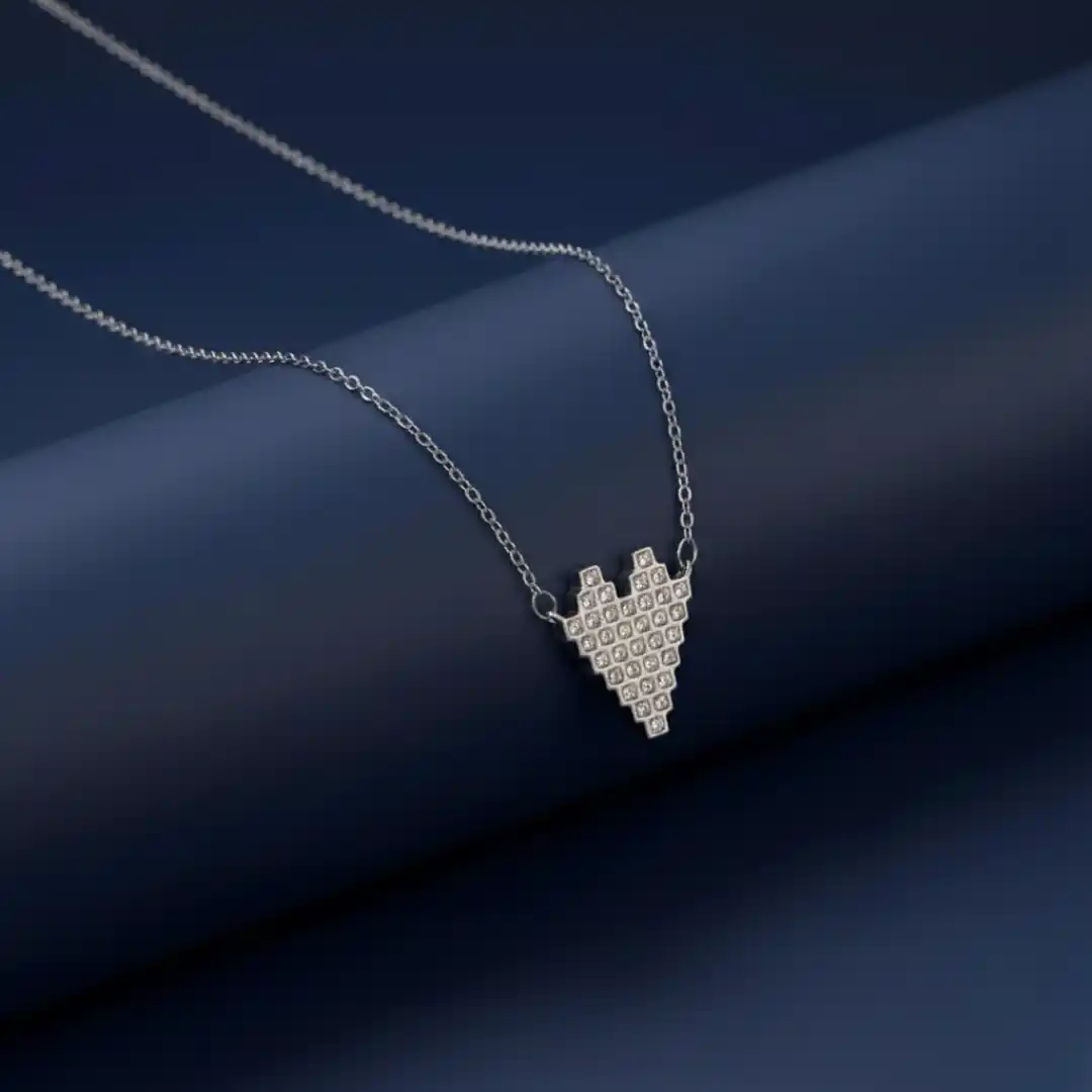 Silver pixelated heart chain pendant with a modern minimal design – available at The Velvet Box.