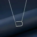 A sparkling silver chain pendant for women in an Alphabet U horseshoe shape.