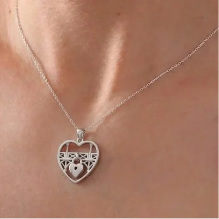 Silver Heart Pendant Necklace with Intricate Design and Gemstone Accent