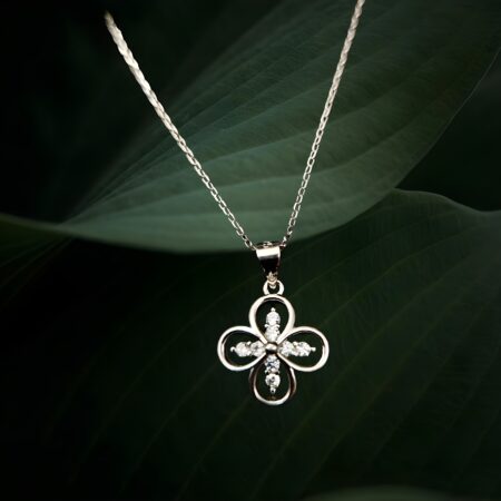 Silver four-leaf clover locket pendant necklace with crystal accents,