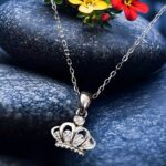 Minimalist silver crown pendant necklace with small crystal accents,