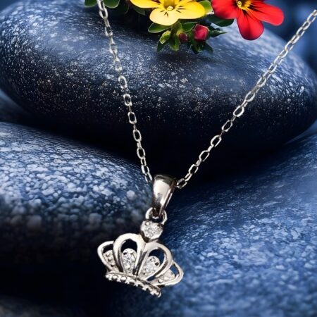 Minimalist silver crown pendant necklace with small crystal accents,