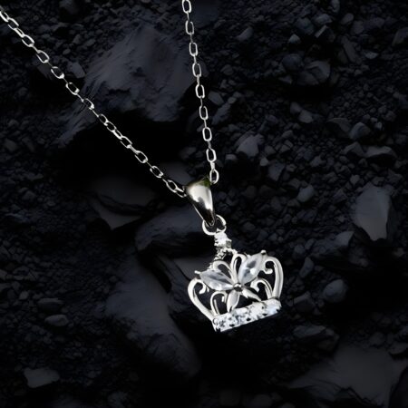Close-up of a silver crown pendant necklace featuring marquise stones, floral detailing