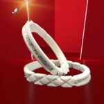 Stylish pair of white belly bangles with engraved silver patterns and a glossy, modern finish