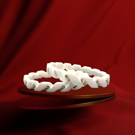 Pair of white plastic bangles with criss-cross diamond pattern design, featuring embedded silver-tone decorative elements