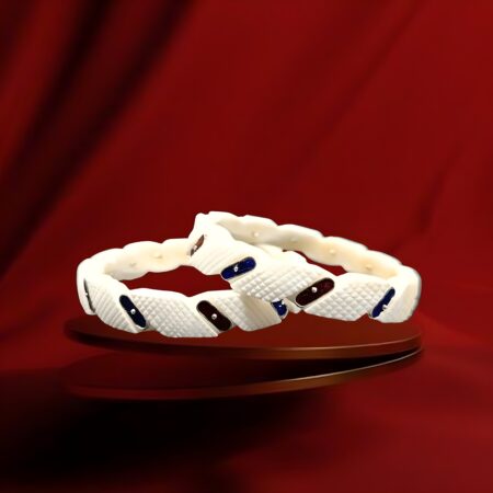 A pair of white braided bangles with small rectangular colored accents in blue and maroon, fastened by tiny metal rivets.