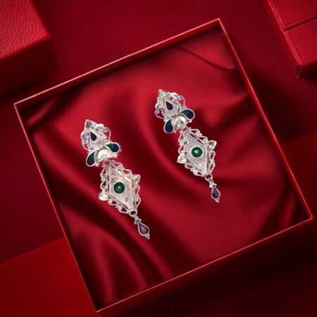 Elegant silver-toned ethnic earrings with intricate design and colorful gemstone accents.