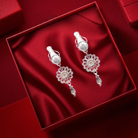 Elegant silver floral dangle earrings with intricate detailing.