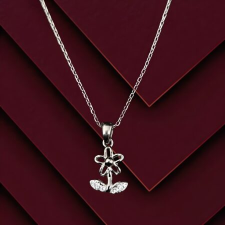 Silver flower locket pendant necklace with crystal-accented leaves on a fine silver chain, displayed on a black background.