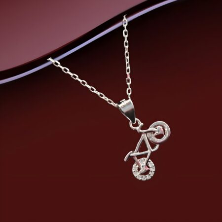 Silver bicycle locket pendant necklace with sparkling wheel detail on a fine silver chain, displayed on a black background.