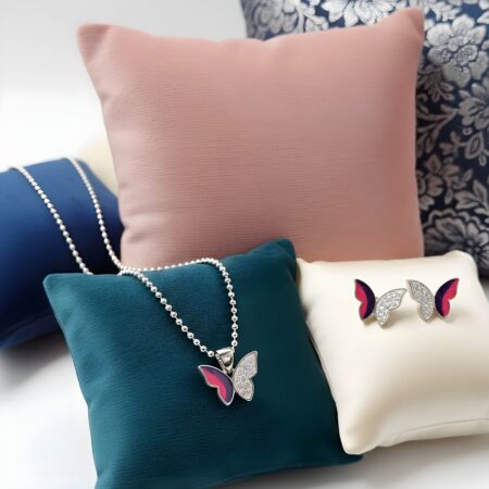 Silver butterfly jewelry set with pink and purple enamel wings, featuring a crystal-studded pendant on chain and matching stud earrings