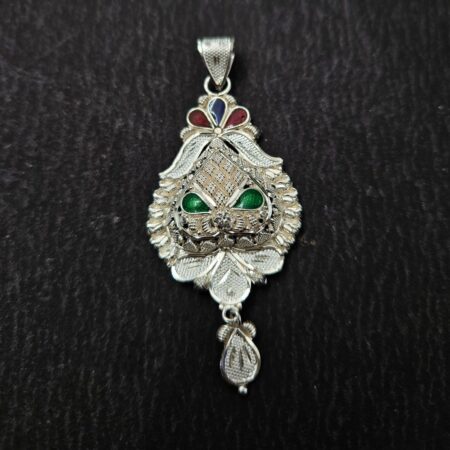 Intricately designed silver locket with floral and leaf patterns, featuring red, blue, and green enamel accents and a detailed hanging motif.