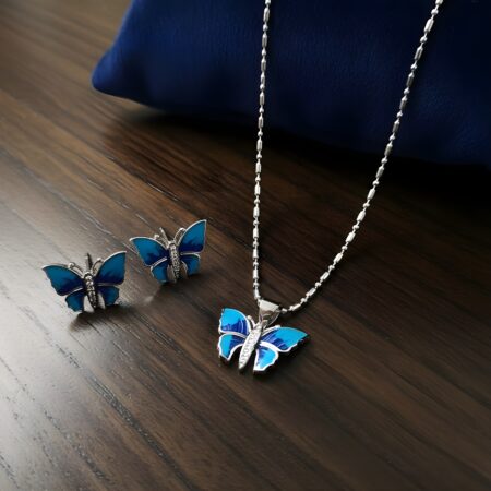 Stylish silver butterfly jewelry set featuring a blue enamel butterfly pendant necklace with matching stud earrings.