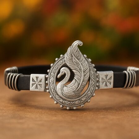 Handcrafted silver bracelet with an elegant swan design centerpiece, set on a black band with traditional ethnic detailing.