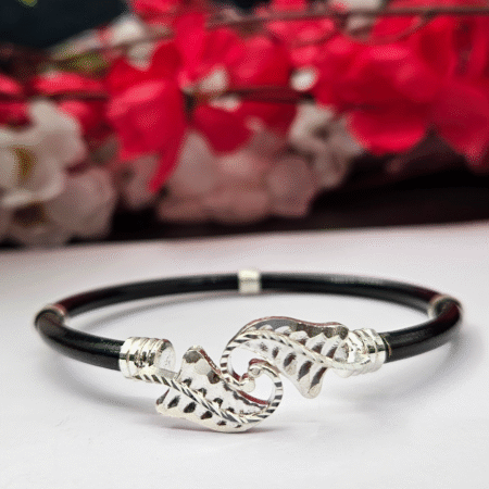 Elegant black bracelet featuring dual silver leaf-shaped motifs at the center, joined with sleek silver accents