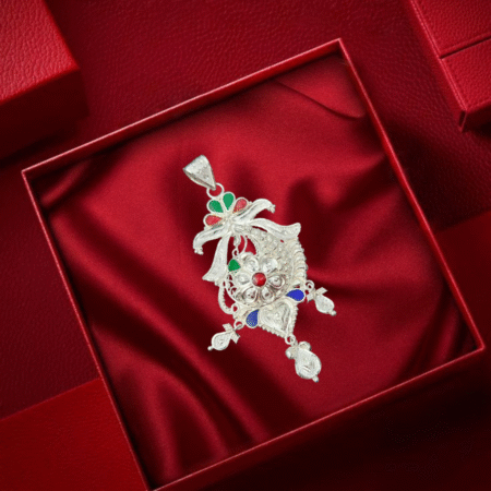Elegant silver locket with intricate floral and ribbon design, featuring red, green, and blue enamel accents, and detailed hanging motifs