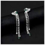 Elegant long silver dangle earrings featuring sparkling diamonds with cascading chains and green teardrop gemstones.