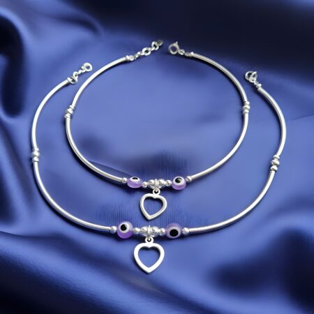 Elegant 925 silver anklets featuring purple evil eye beads and open heart charms, designed for women. The anklets have a sleek, polished silver finish with adjustable chains for a perfect fit.