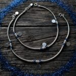 Pair of 925 sterling silver anklets for women featuring blue beads and round dangling charms, designed with a sleek and elegant finish.