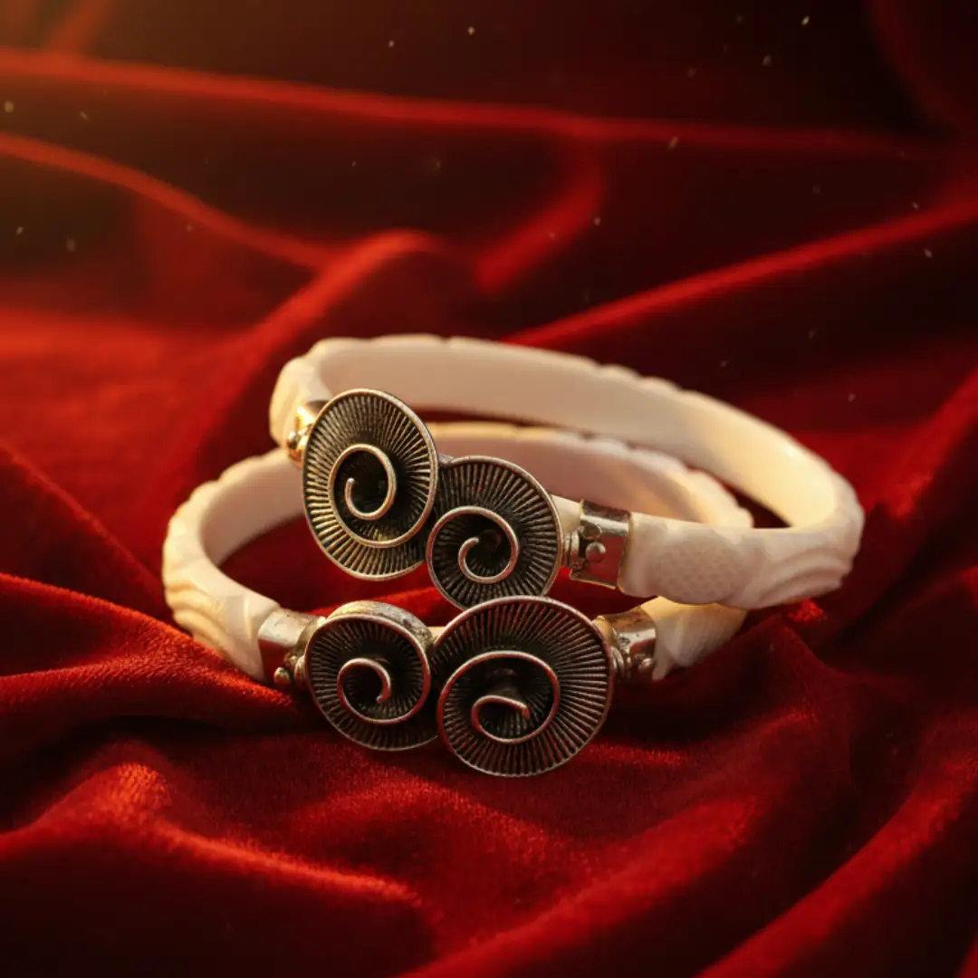 Luxury Silver Shakha Bangles featuring a silver elephant motif and blue-green teardrop gemstones by The Velvet Box.